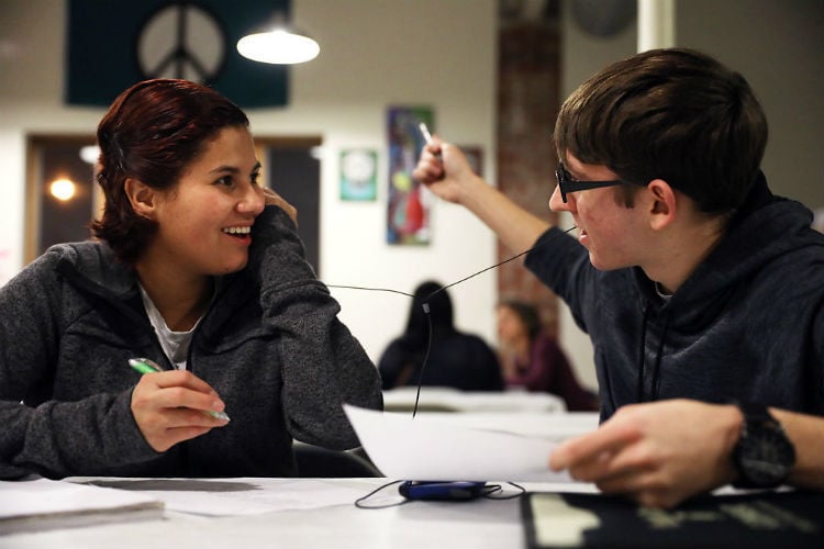 Ethan Morrow, right, explains the word “peace” to his student